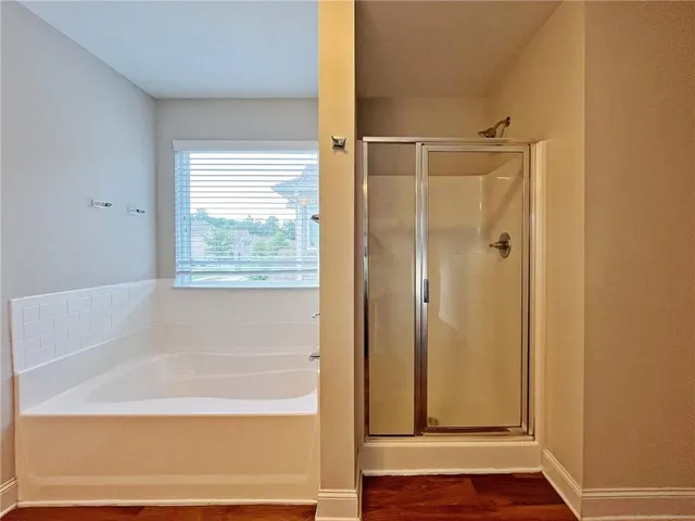 a bathroom with a bathtub and shower