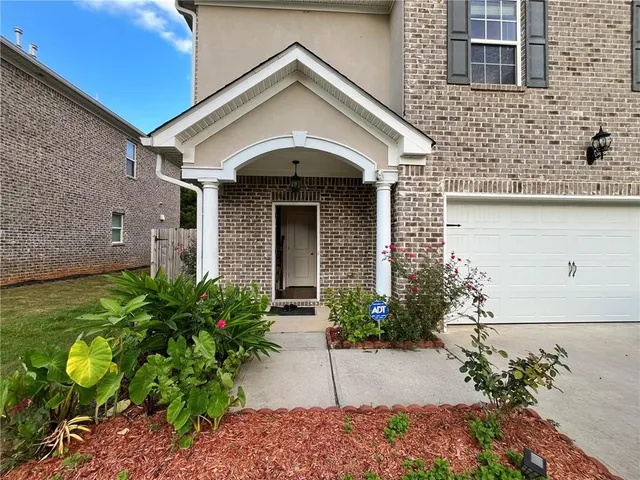 a front view of a house with garden