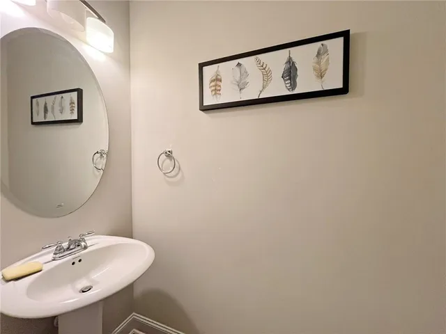 a bathroom with a sink and mirror