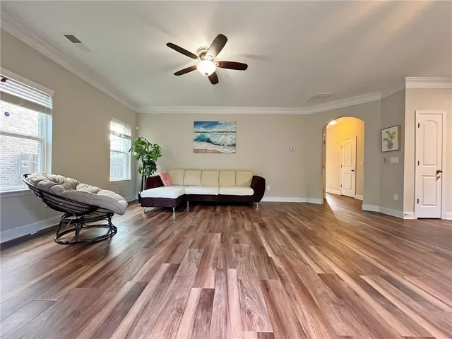 a living room with furniture fireplace and wooden floor