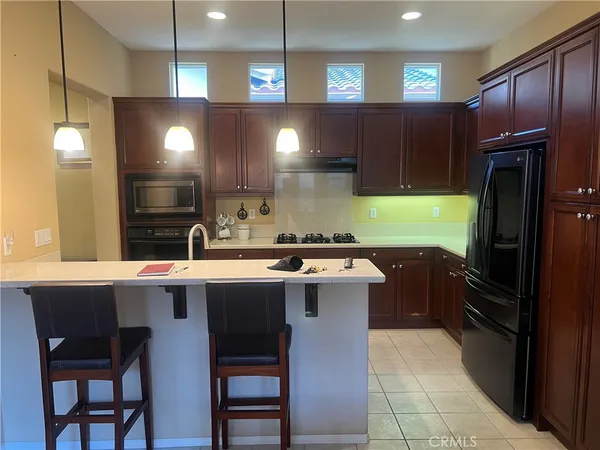 a kitchen with a sink refrigerator and cabinets