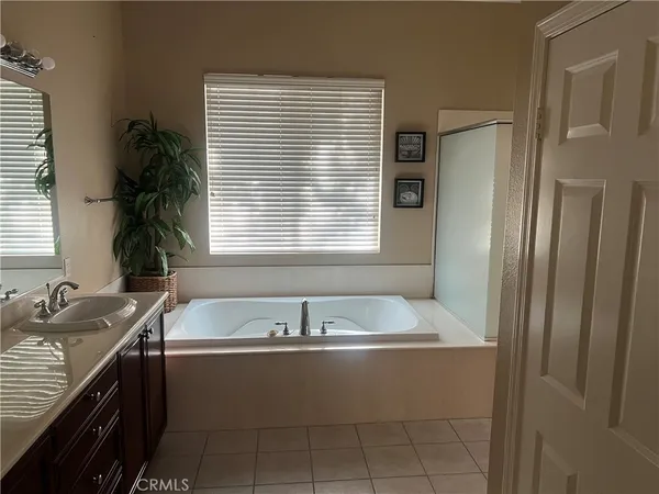 a bath tub sitting in a bathroom next to a window