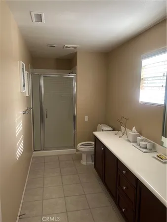 a bathroom with a double vanity sink toilet and shower