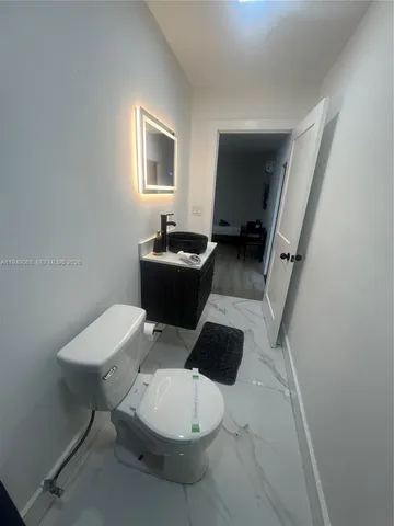 a view of a livingroom with furniture and white walls