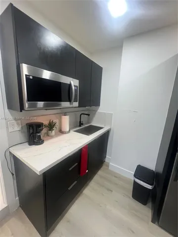 a kitchen with a stove and a microwave