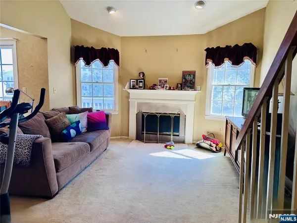a living room with furniture a fireplace and a potted plant