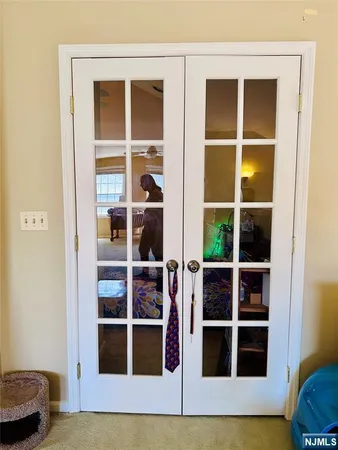 a view of a bedroom with wooden floor and closet