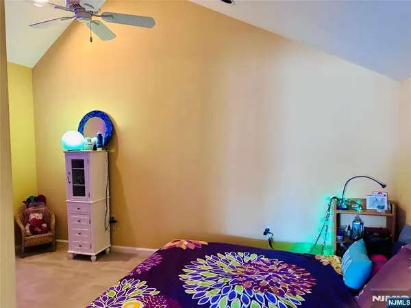 a bedroom with a bed a couch and a chandelier