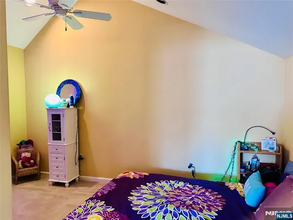 a bedroom with a bed a couch and dresser