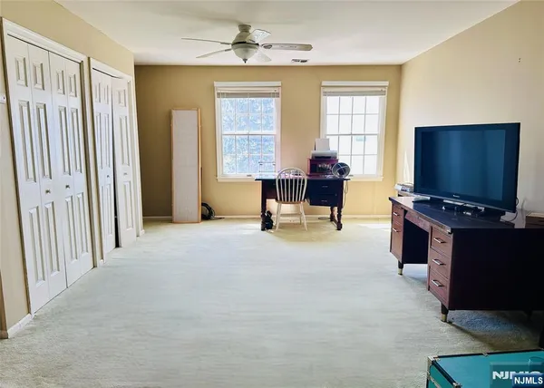 a view of a livingroom with furniture and a window