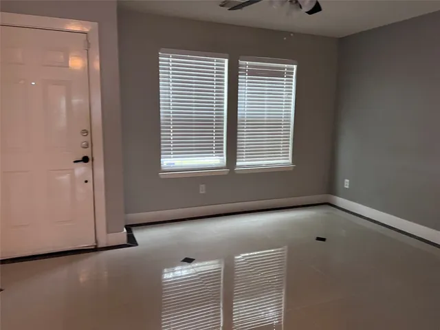 a view of room with a window and ceiling fan