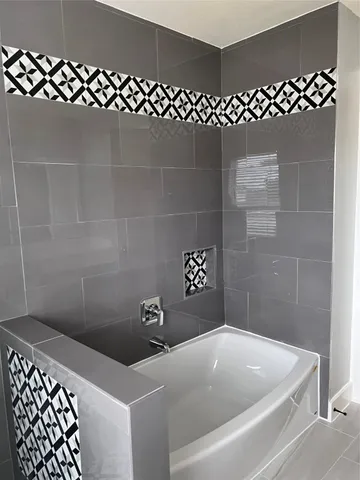 a bathroom with a black white checkered floor
