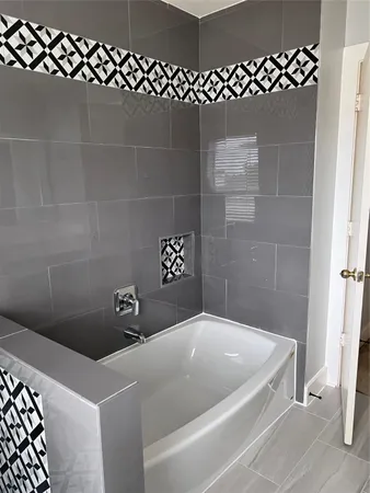 a bathroom with a granite countertop sink and a window