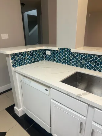 a white stove top oven sitting inside of a kitchen