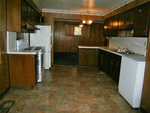 a kitchen with a refrigerator and sink