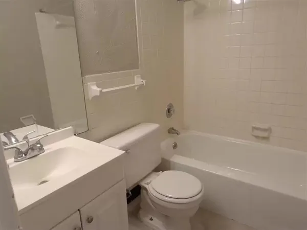 an empty room with windows and closet area