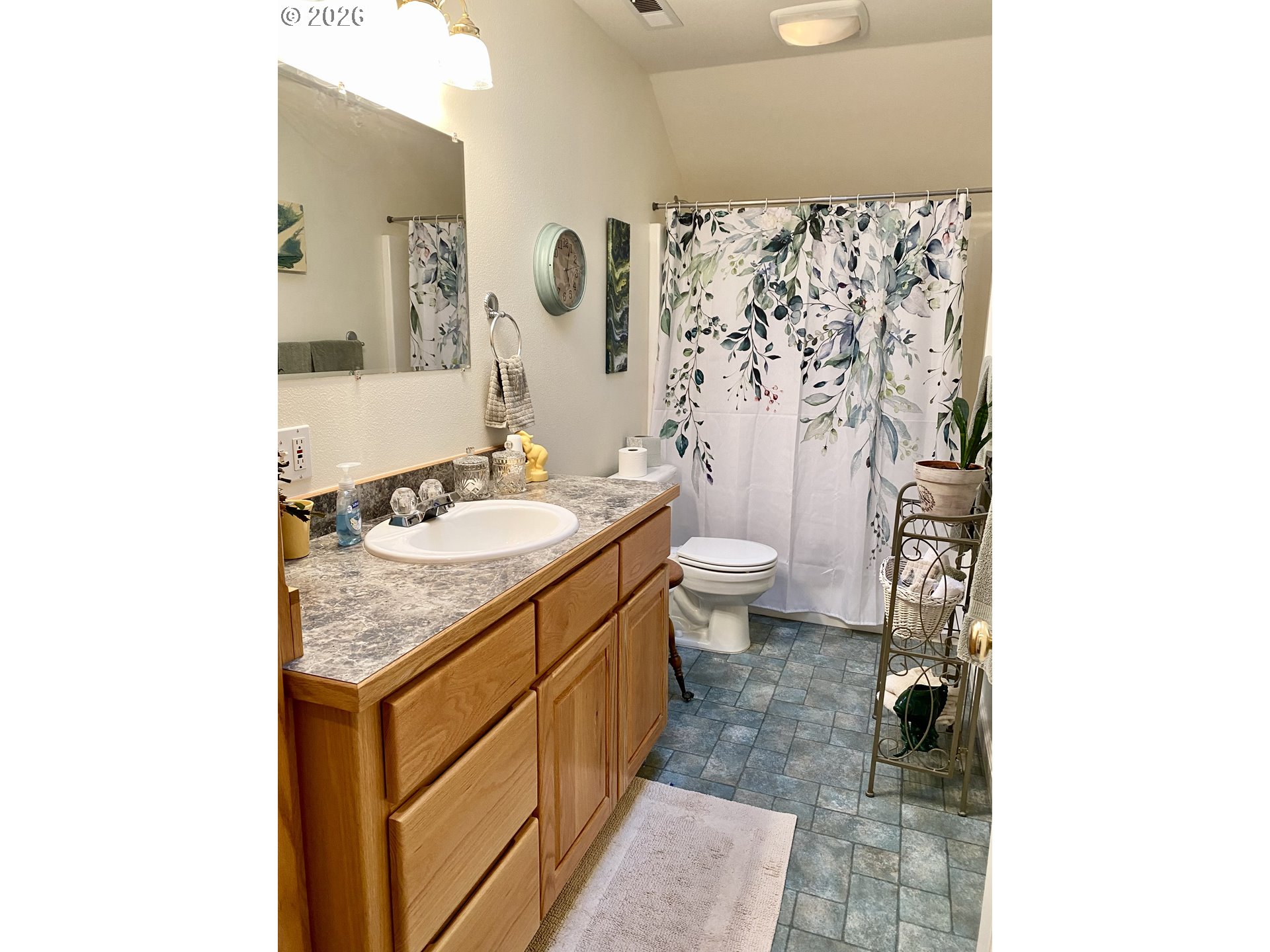 3555 Indiana Avenue Baker City, OR 97814 - Photo 20 of 43 a bathroom with a granite countertop sink a toilet and a shower