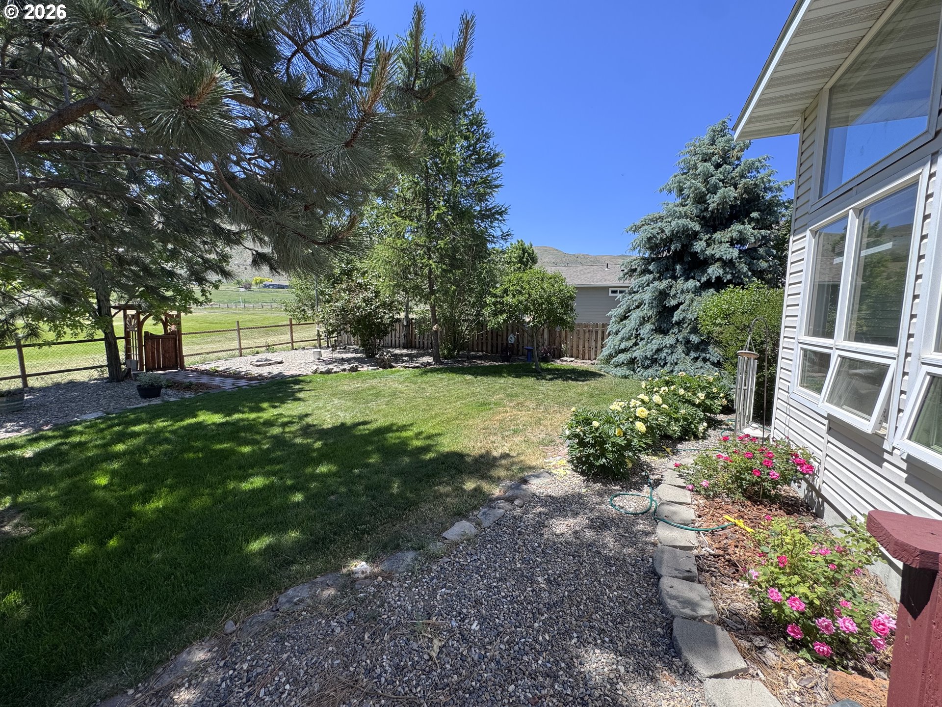 3555 Indiana Avenue Baker City, OR 97814 - Photo 35 of 43 a view of a backyard with potted plants and large trees