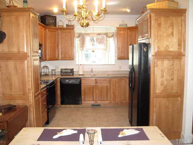 3426 Barron Berkeley Way Raleigh, NC 27612 - Photo 4 of 14 Spacious kitchen with solid surface counters & black appliances Kitchen