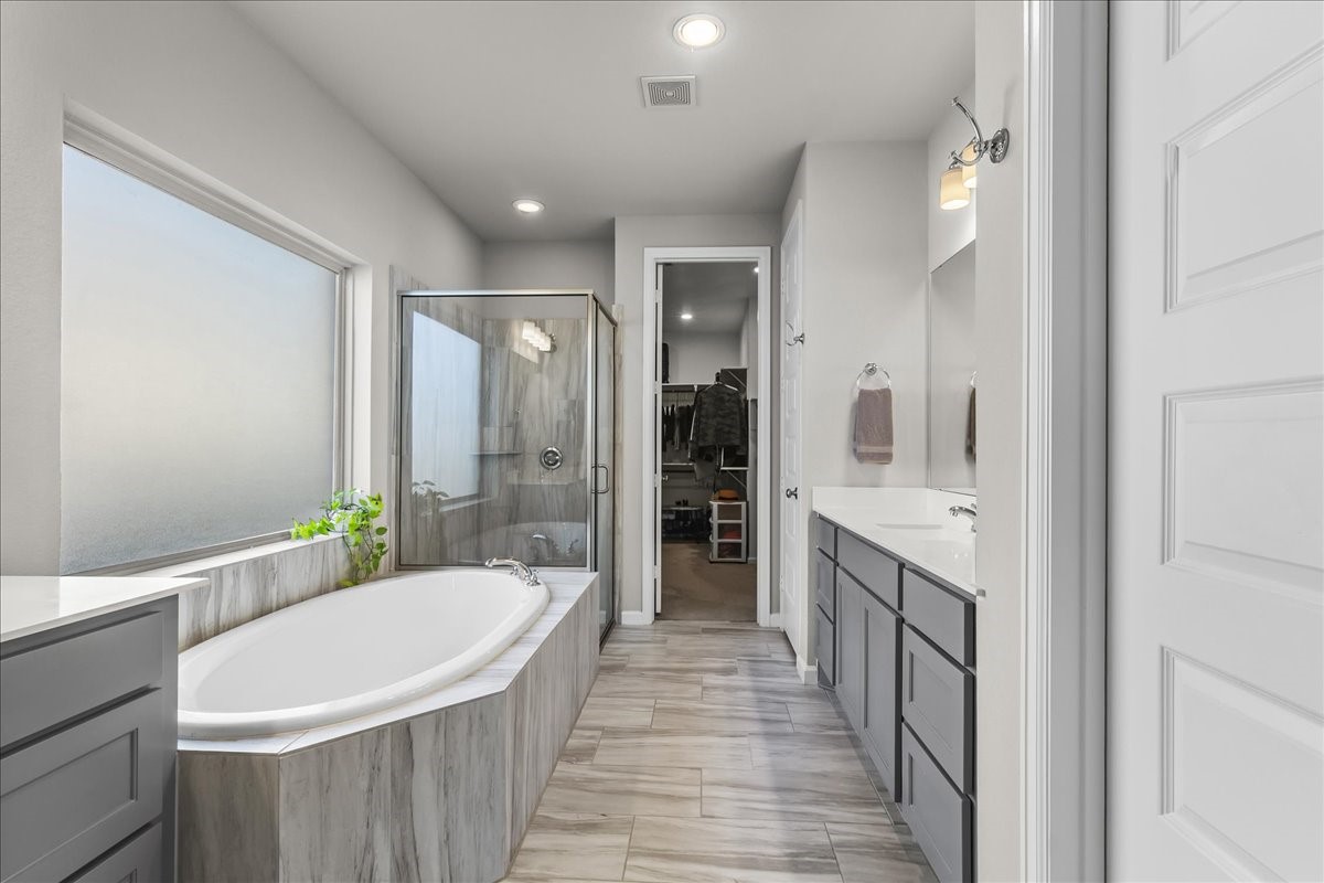 4910 Morrison Drive Manvel, TX 77578 - Photo 13 of 35 a bathroom with a bathtub a sink a mirror and a shower