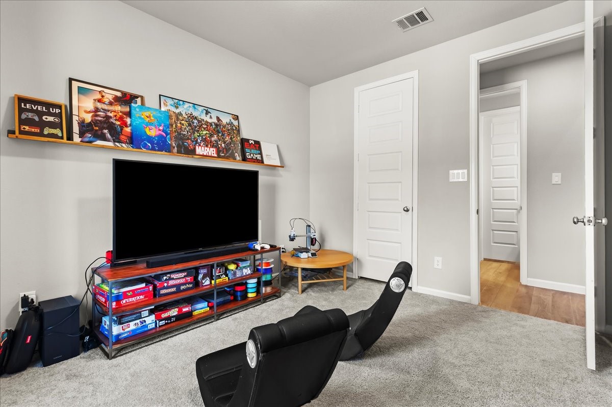 4910 Morrison Drive Manvel, TX 77578 - Photo 19 of 35 a living room with furniture and a flat screen tv