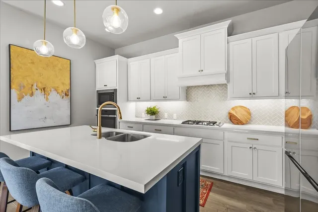 a kitchen with a sink a stove and cabinets