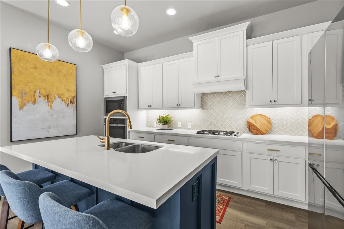 4910 Morrison Drive Manvel, TX 77578 - Photo 3 of 35 a kitchen with a sink a stove and cabinets