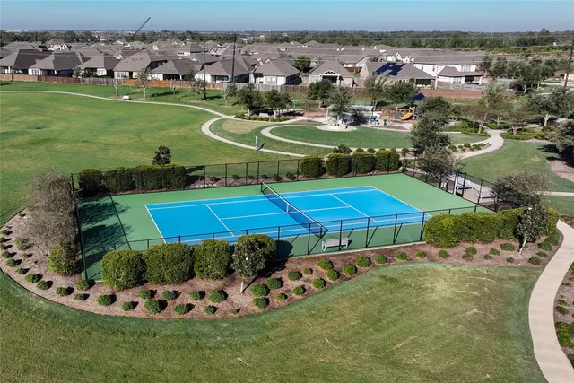 an aerial view of a house with a yard