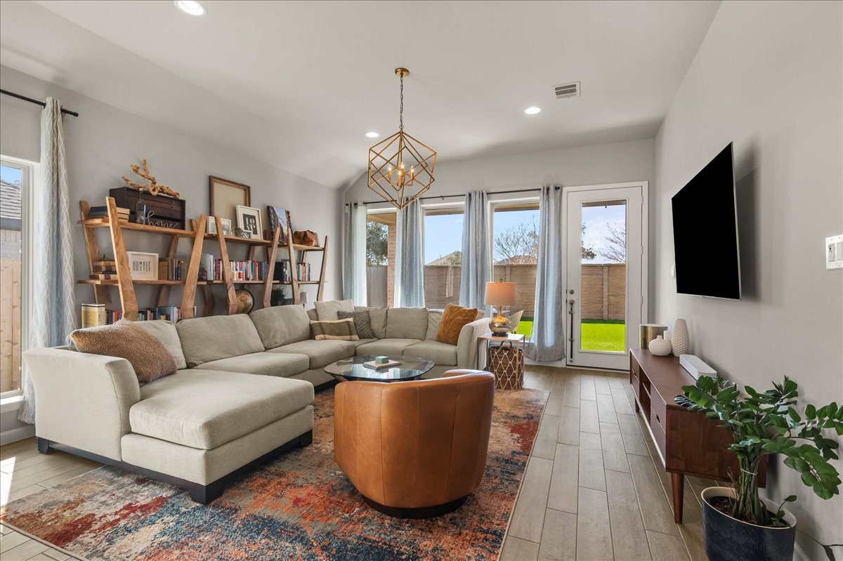 4910 Morrison Drive Manvel, TX 77578 - Photo 6 of 35 a living room with furniture a flat screen tv and a large window
