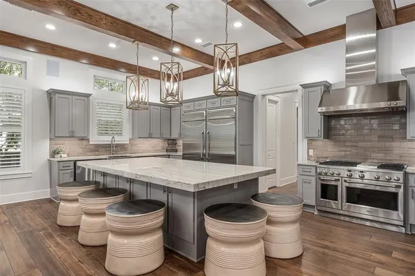 a kitchen with a stove a sink and a refrigerator