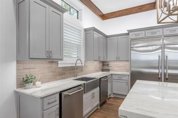 a kitchen with a sink stove and cabinets