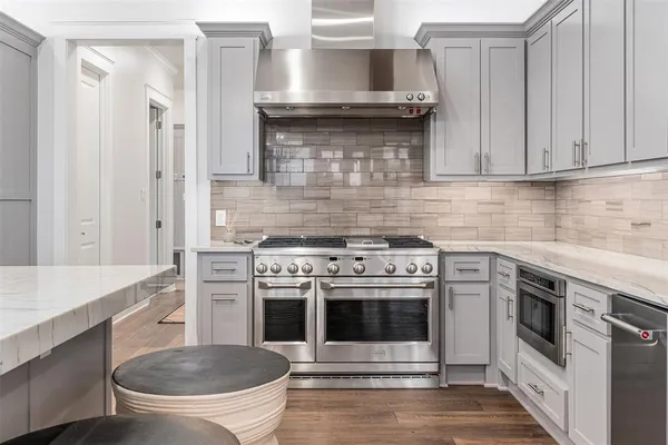 a kitchen with a stove and white cabinets