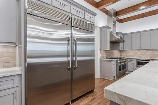 a kitchen with stainless steel appliances kitchen island a refrigerator and a stove
