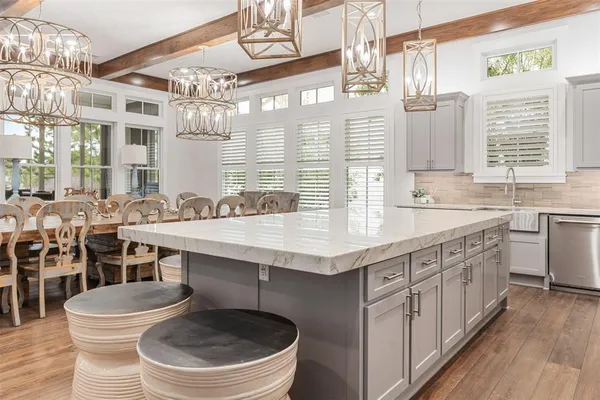 a bathroom with a sink a mirror a toilet and a window