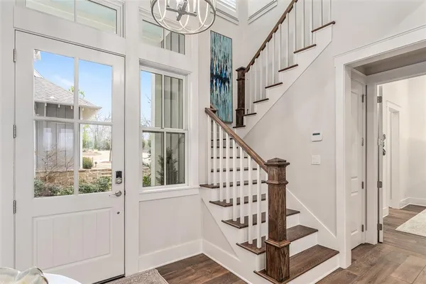 a view of entryway with wooden floor and stairs