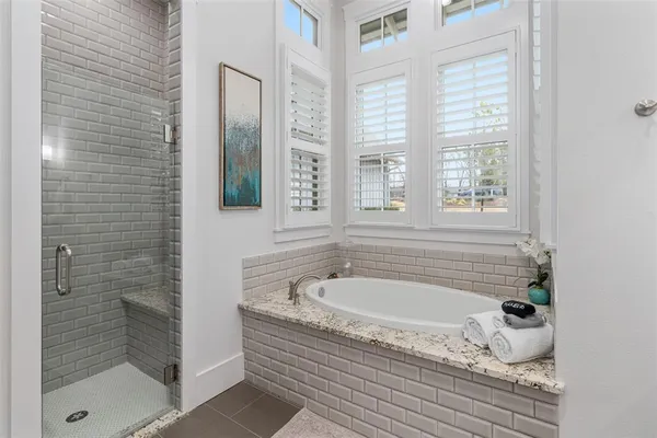 a bathroom with bathtub and shower