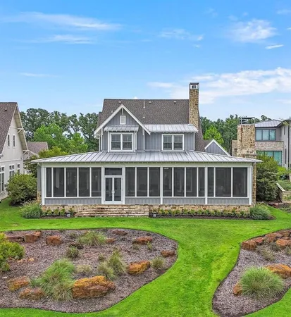 a view of a lush green outdoor space with a swimming pool and outdoor seating