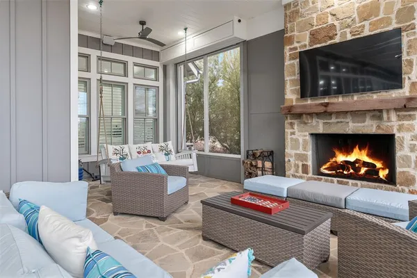 a living room with furniture a fireplace and a flat screen tv
