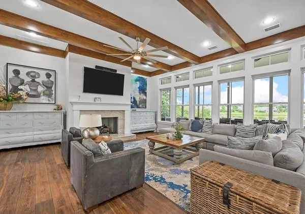 a living room with fireplace furniture and a flat screen tv