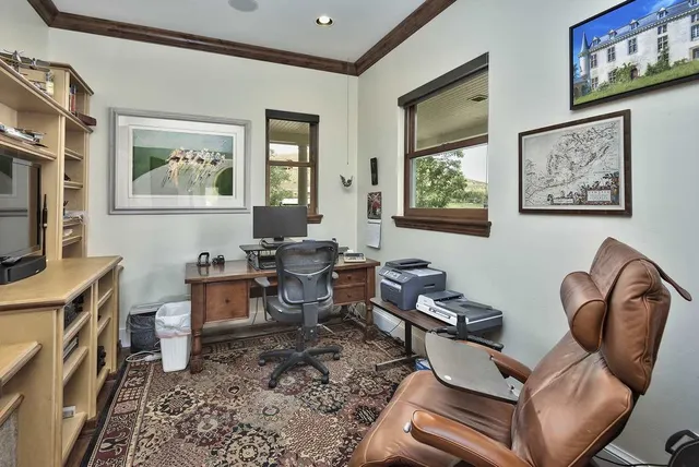 a living room with furniture a window and a flat screen tv