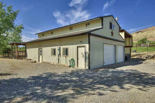 a front view of a house with a road