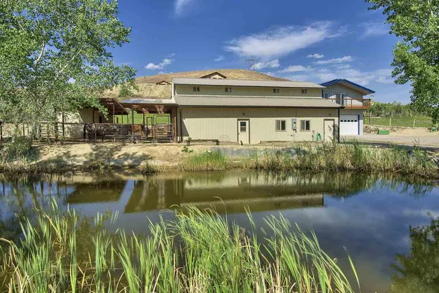 a front view of a house with a lake view
