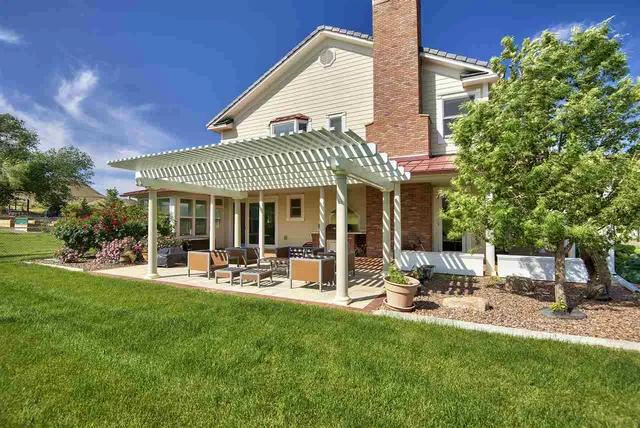a front view of a house with a yard table and chairs