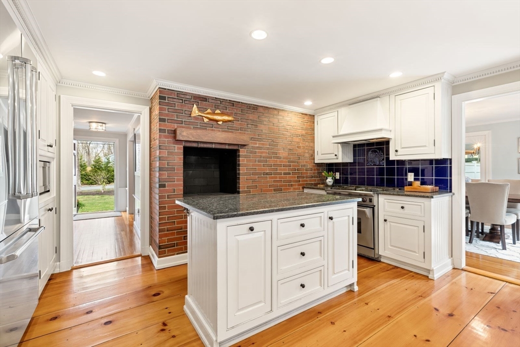 2 Yorkshire Road Dover, MA 02030 - Photo 13 of 42 a kitchen with stainless steel appliances kitchen island granite countertop a refrigerator a sink dishwasher and white cabinets with wooden floor