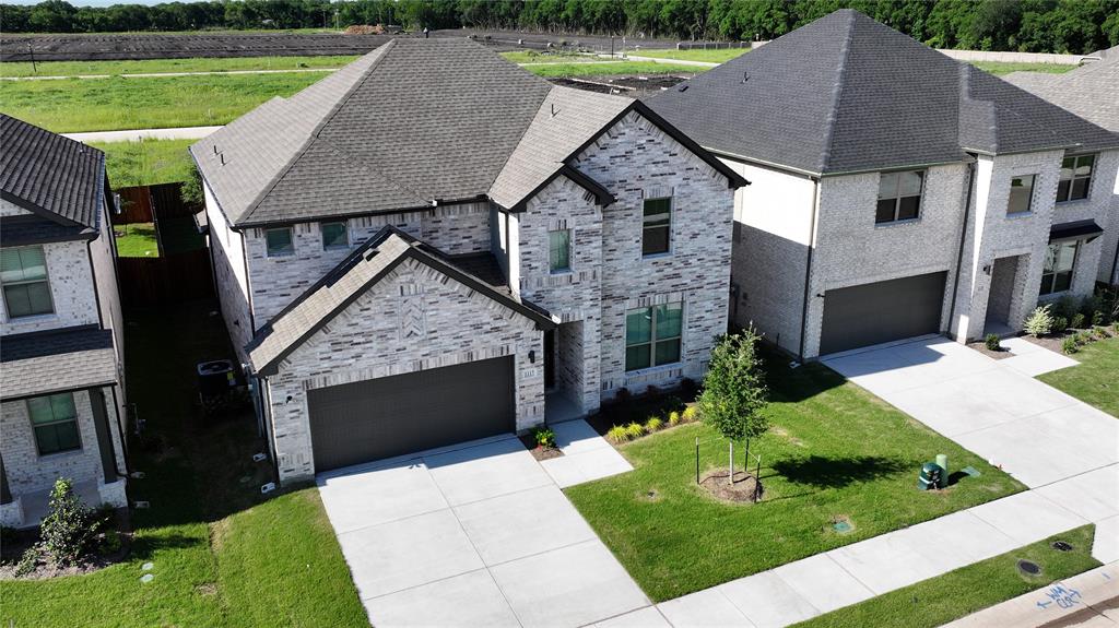 a aerial view of a house with a yard deck and a patio