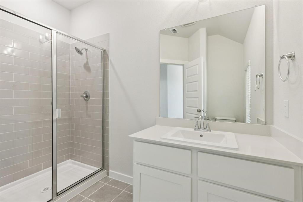 1117 Sunward Road Princeton, TX 75407 - Photo 15 of 34 a bathroom with a shower sink and mirror