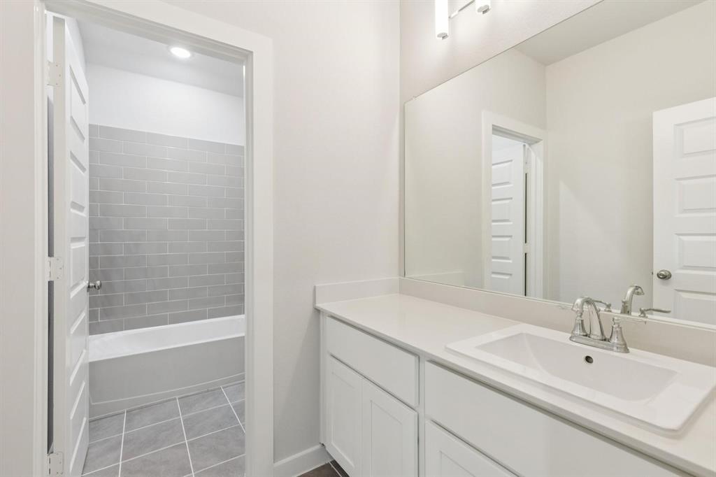 1117 Sunward Road Princeton, TX 75407 - Photo 24 of 34 a bathroom with a sink and a mirror