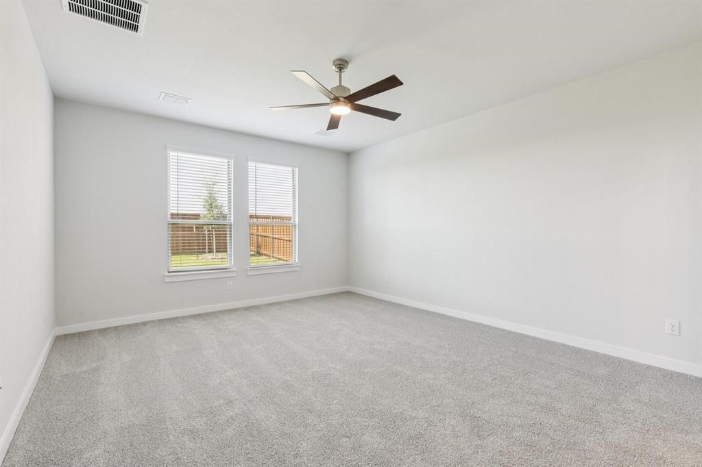 1117 Sunward Road Princeton, TX 75407 - Photo 10 of 34 an empty room with windows and ceiling fan