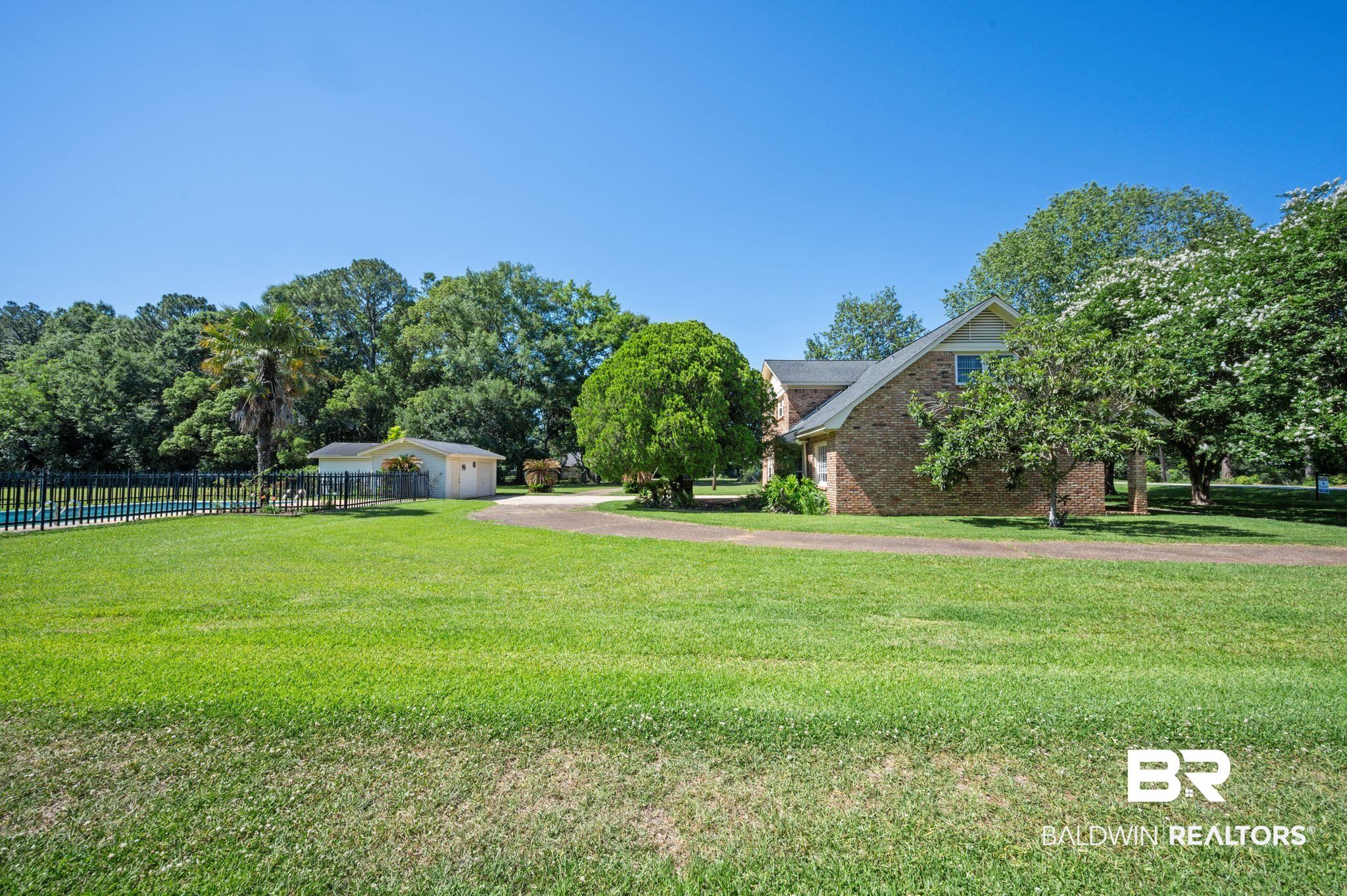 950 Walter Smith Road Mobile, AL 36695 - Photo 36 of 51 View of yard featuring driveway and a garage
