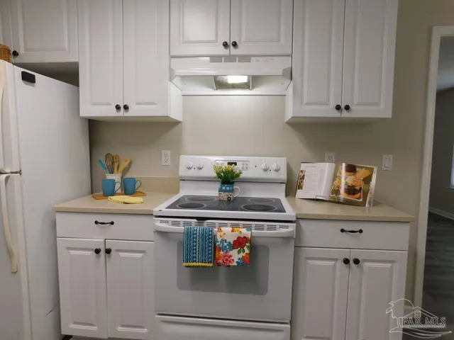 a kitchen with stainless steel appliances granite countertop a stove a refrigerator and cabinets